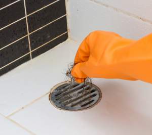 removing strands of hair blocking the drain