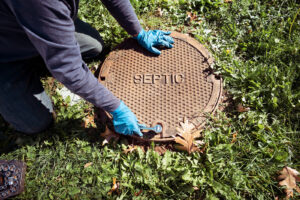 plumber opening septic tank